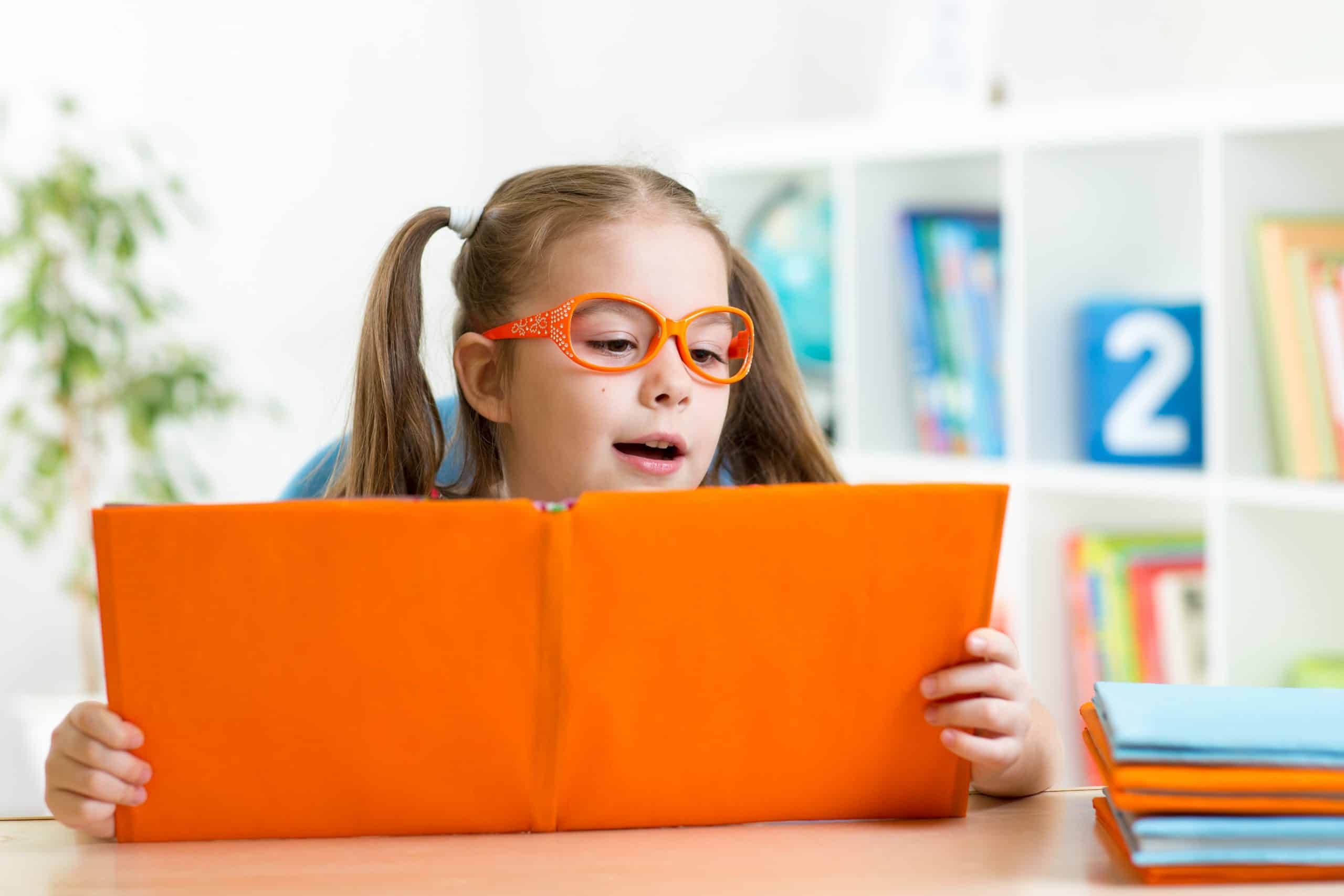 clever child little child behind of open book indoors
